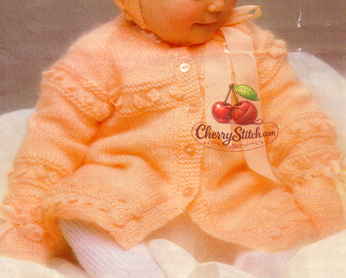 Close-up of bobble and garter stitch horizontal panels on baby coat cardigan – restored vintage 1970s raglan knitting pattern in DK