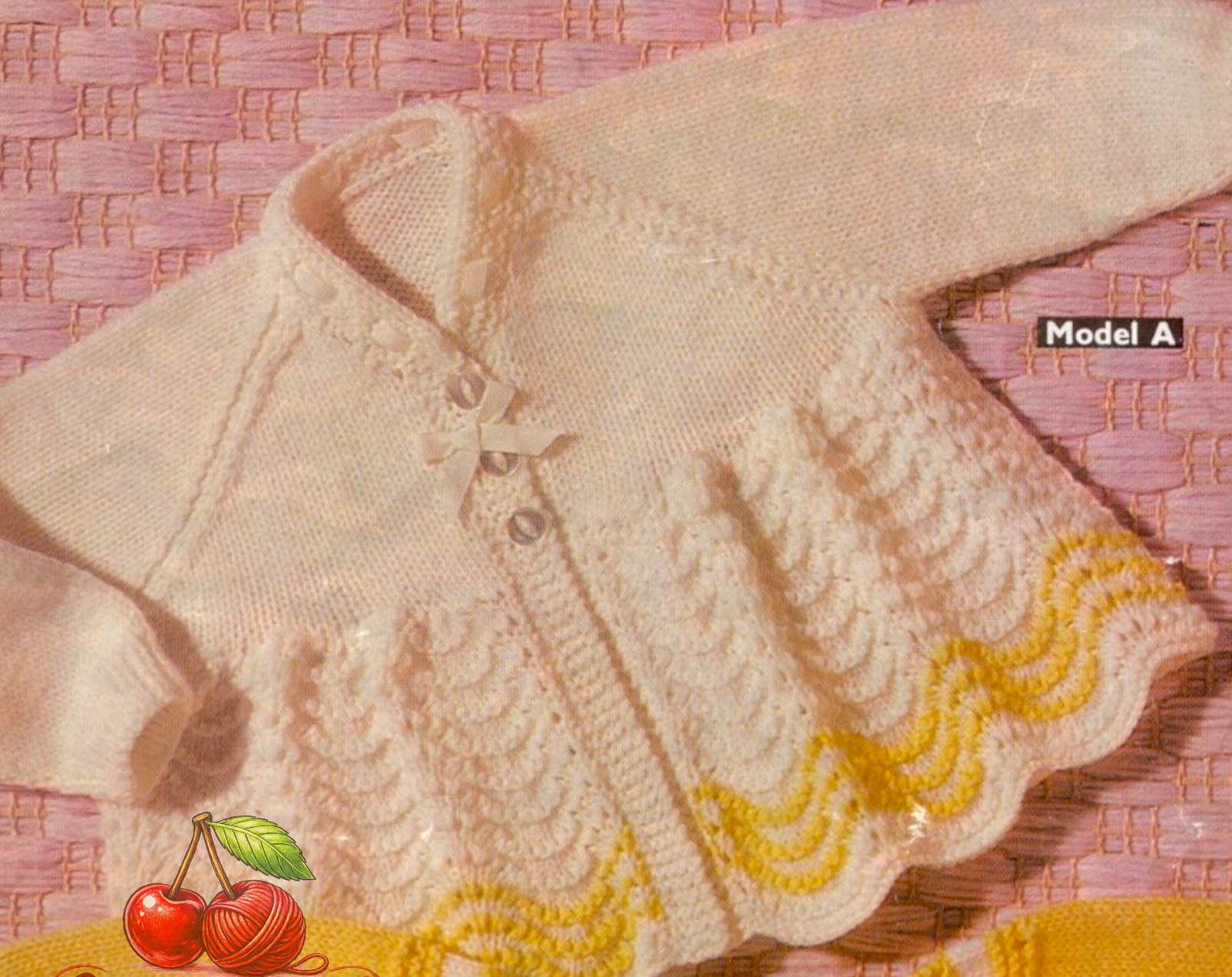 Close-up of raglan sleeve baby matinee coat with flared lace skirt and scalloped wavy hemline. Restored vintage 1960s knitting pattern in 3-ply.