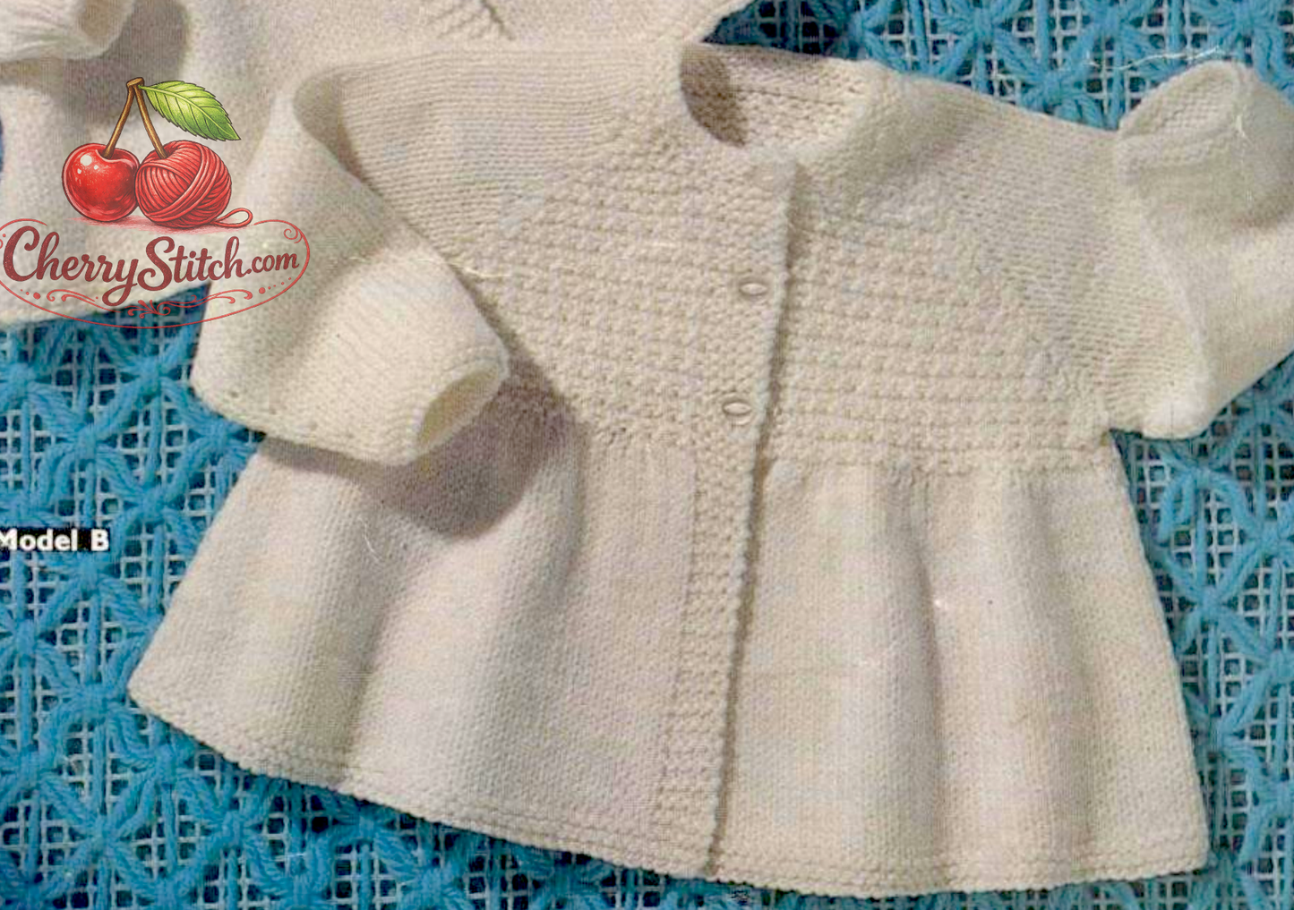 Close-up of raglan sleeve baby matinee coat with decorative patterned front chest panel. Restored vintage 1960s knitting pattern in DK.