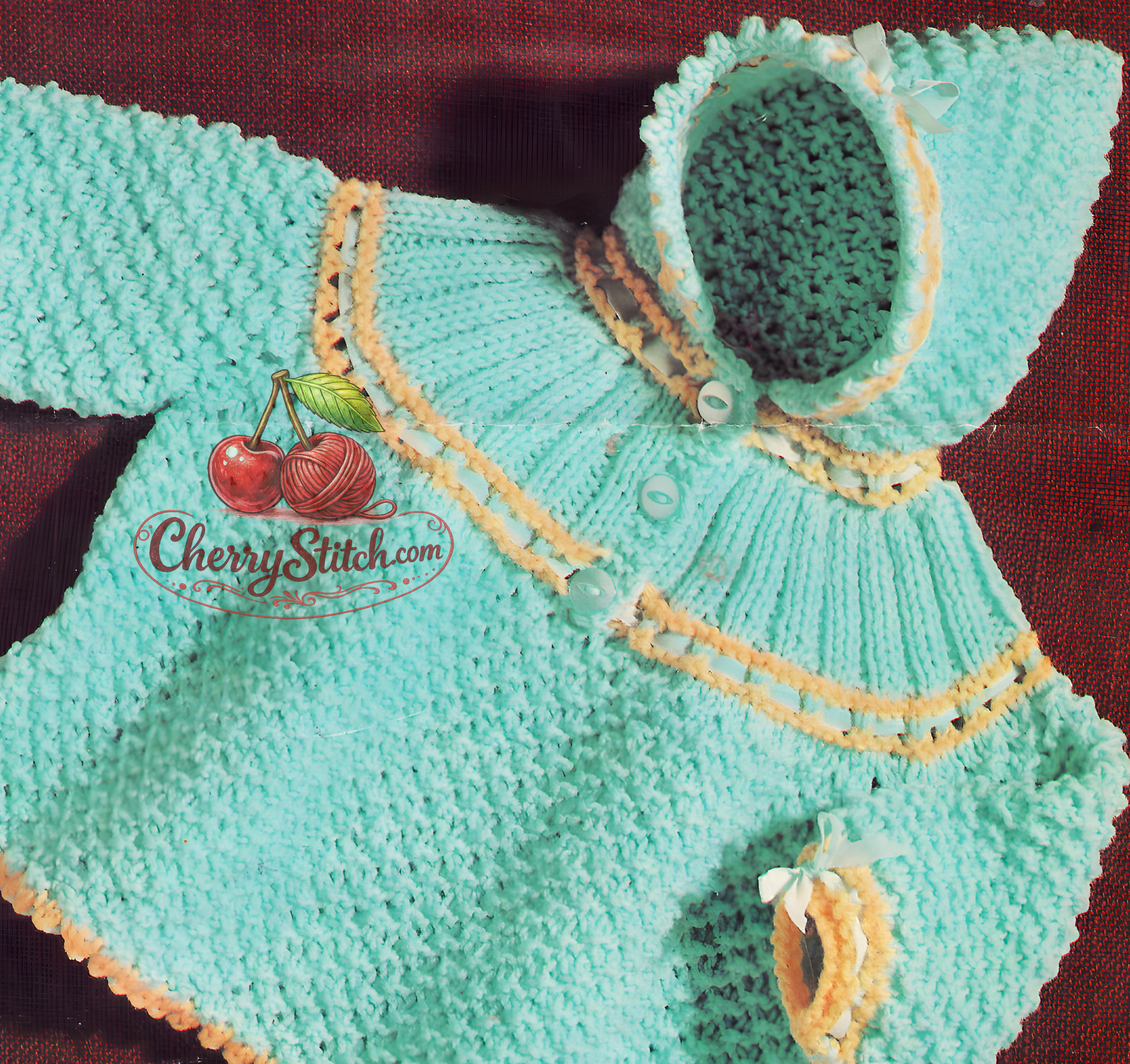 Close-up of baby hooded jumper with thick bobbled texture, structured yoke and pointed pixie hood. Restored vintage 1960s knitting pattern in DK — front and back worked alike.