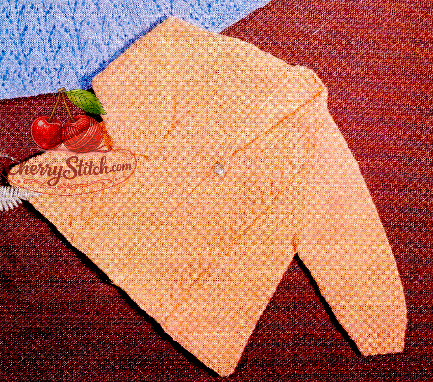Close-up of apricot baby matinee coat with raglan sleeves and vertical cable panels on the front. Restored vintage 1960s knitting pattern in 3-ply.