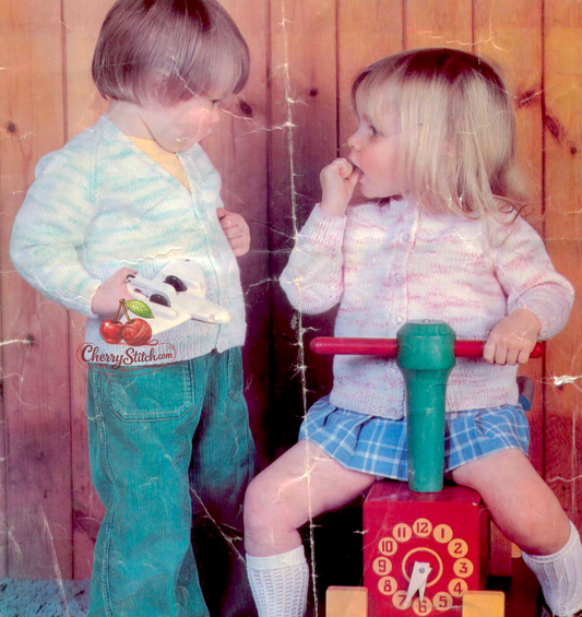 Vintage 1970s baby cardigan knitting pattern. 2 neckline options — classic V-neck and round crew neck, both with raglan sleeves in smooth stocking stitch. DK, 21''–22'', 18 months and 2 years.