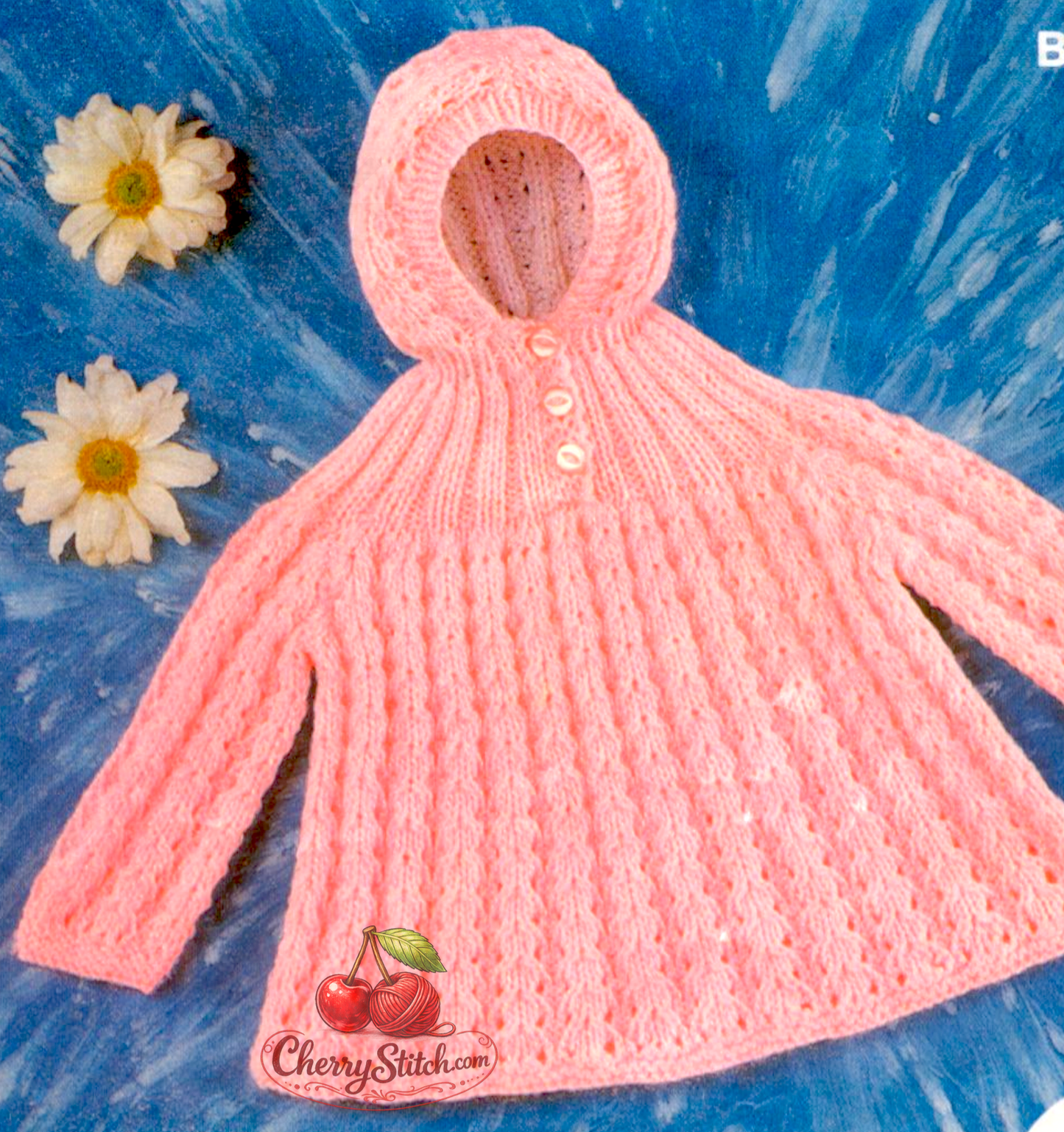 Close-up of flared hem on vintage 1970s baby hooded angel top. Restored knitting pattern in DK — soft, flowing silhouette characteristic of vintage baby knitwear.