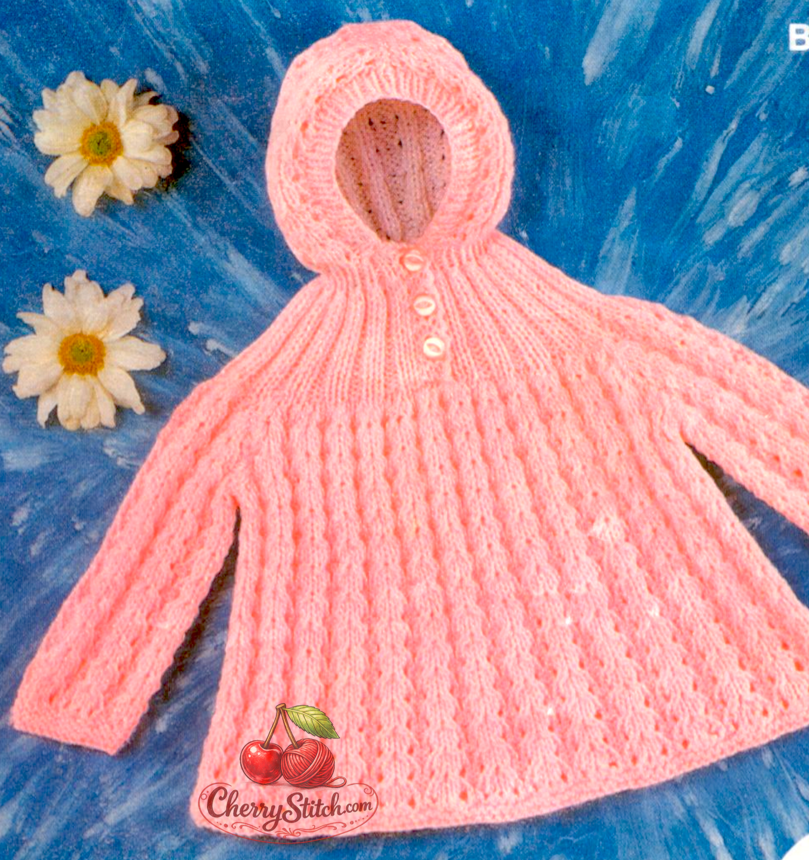 Close-up of flared hem on vintage 1970s baby hooded angel top. Restored knitting pattern in DK — soft, flowing silhouette characteristic of vintage baby knitwear.