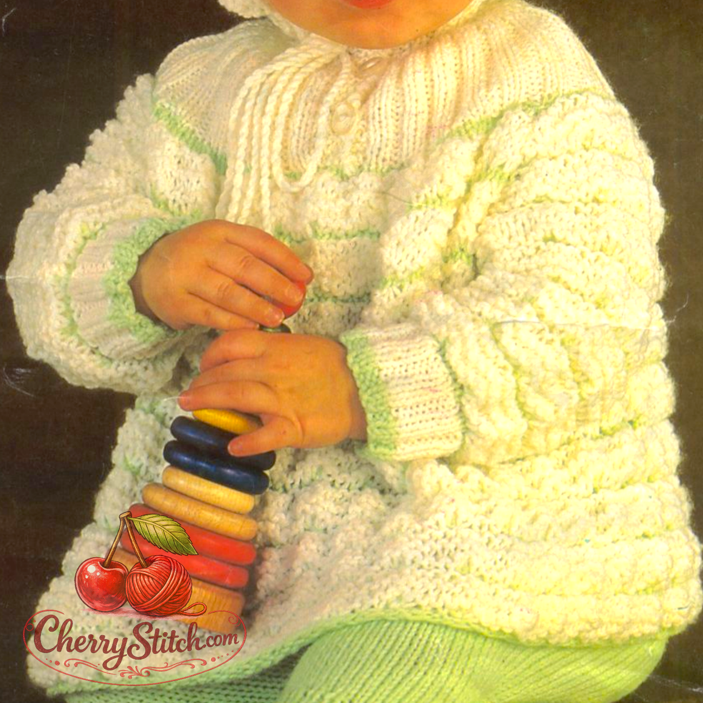 Close-up of vintage 1970s baby hooded coat. Restored knitting pattern in DK — warm, bubbly texture ideal for cooler days and outdoor wear.

