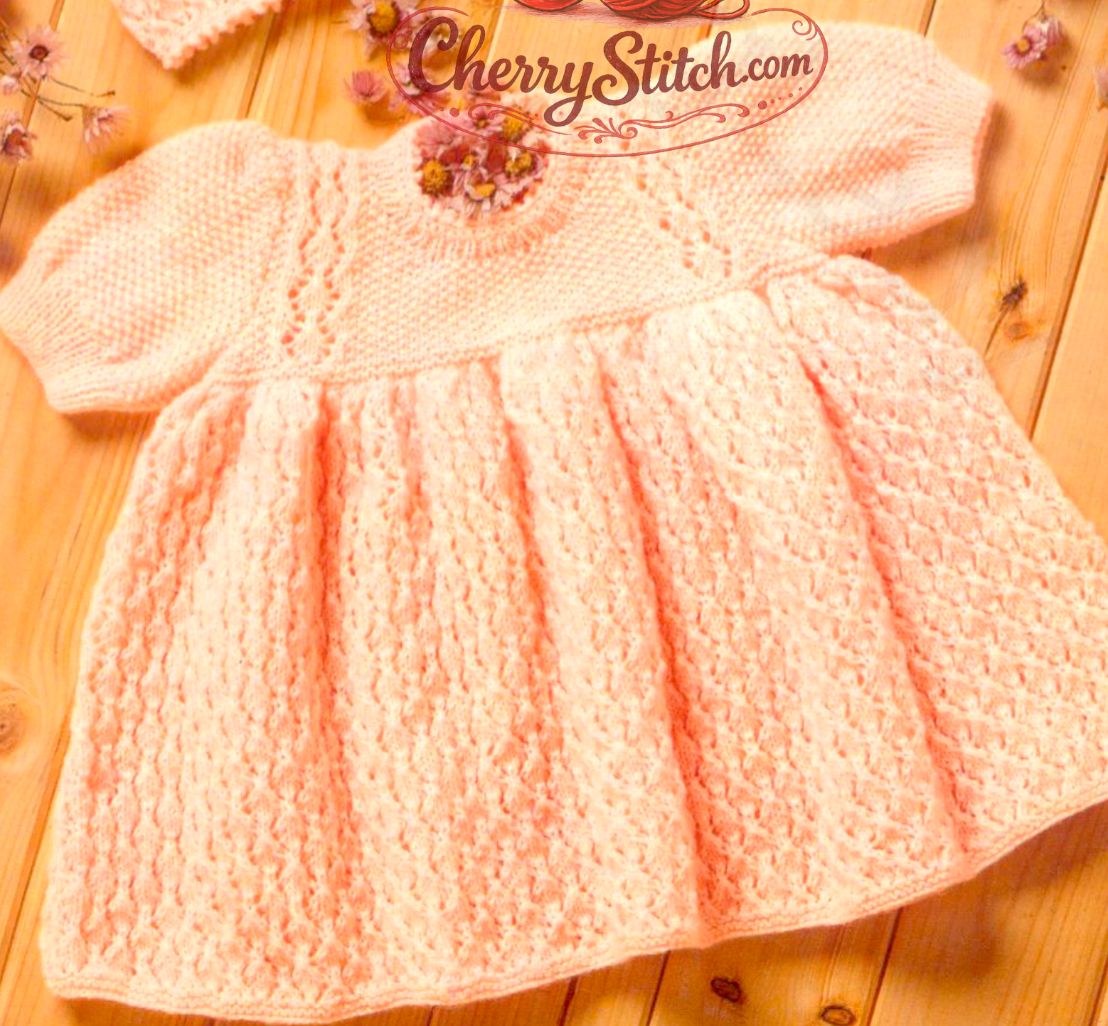 Close-up of the short-sleeved dress from vintage 1980s baby girl dress, matinee coat and bonnet set knitting pattern. Restored design in 4ply moss stitch and lace.