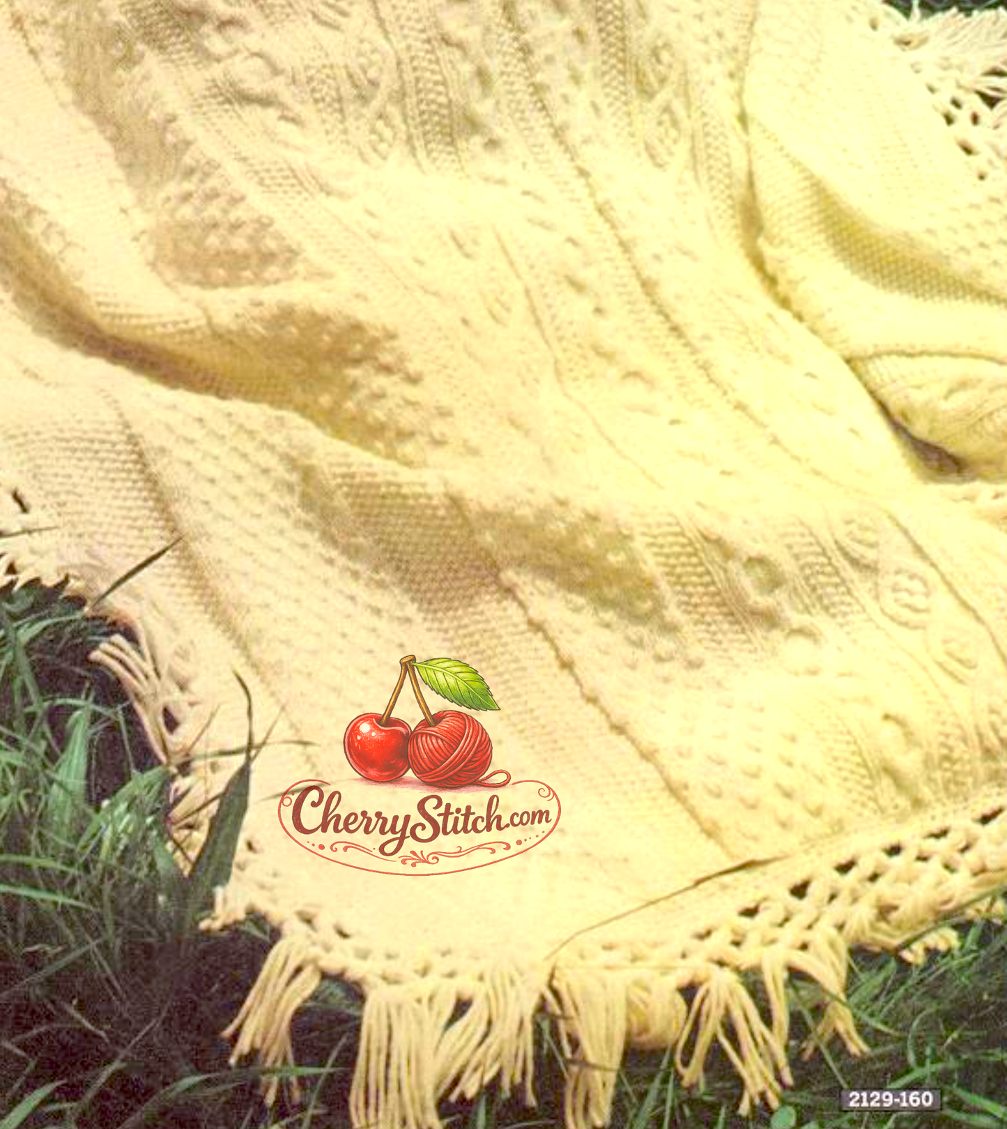 Close-up of Aran stitch texture on vintage 1968 afghan blanket knitting pattern. Restored classic design in Worsted Aran — deeply textured cables, honeycomb and bobbles with fringed edge.
