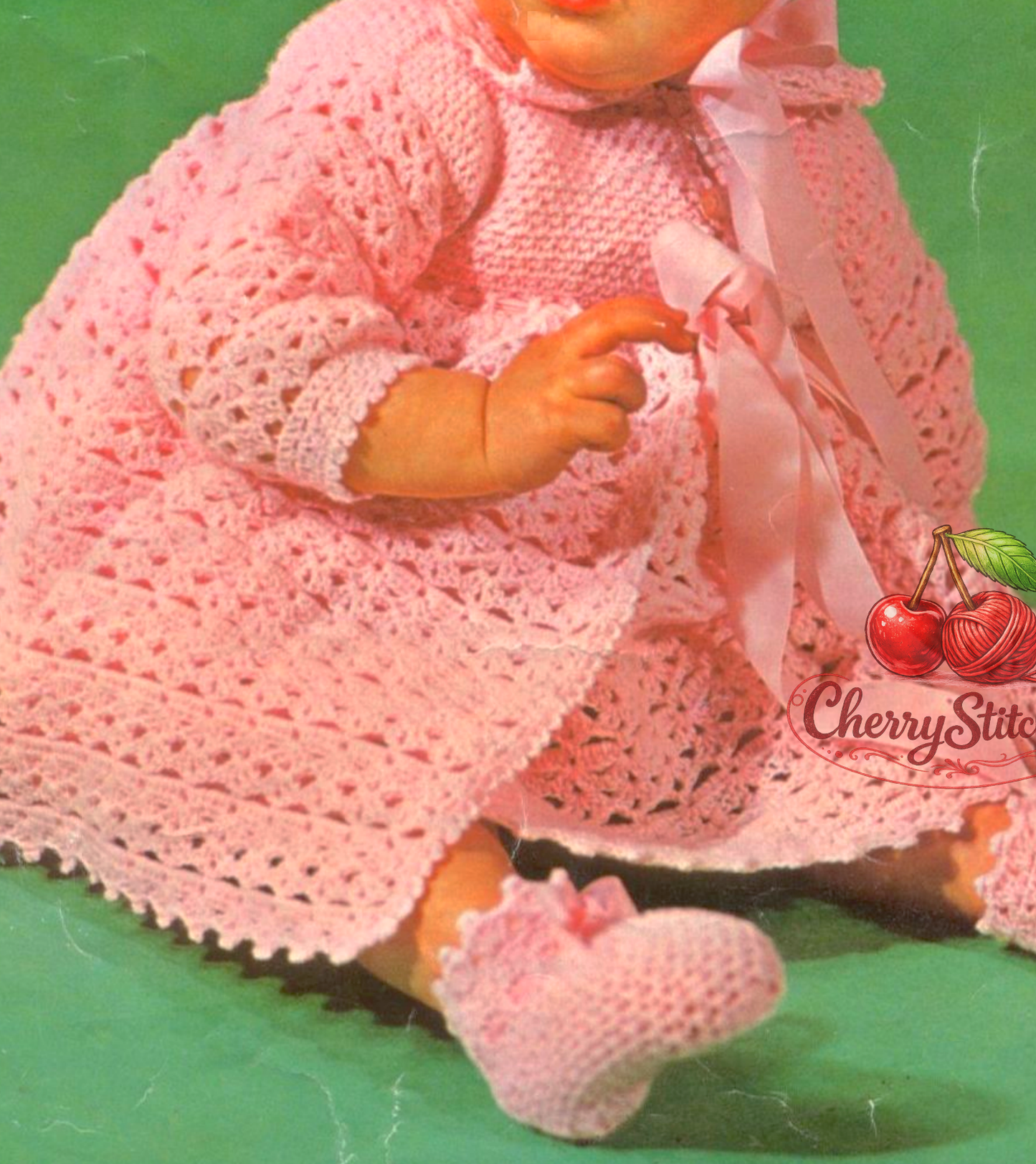Close-up of matinee coat cardigan from vintage 1960s baby layette crochet pattern. Restored heirloom design in lacy shell stitch — delicate, airy fabric in 3ply or 4ply yarn. UK crochet terms.