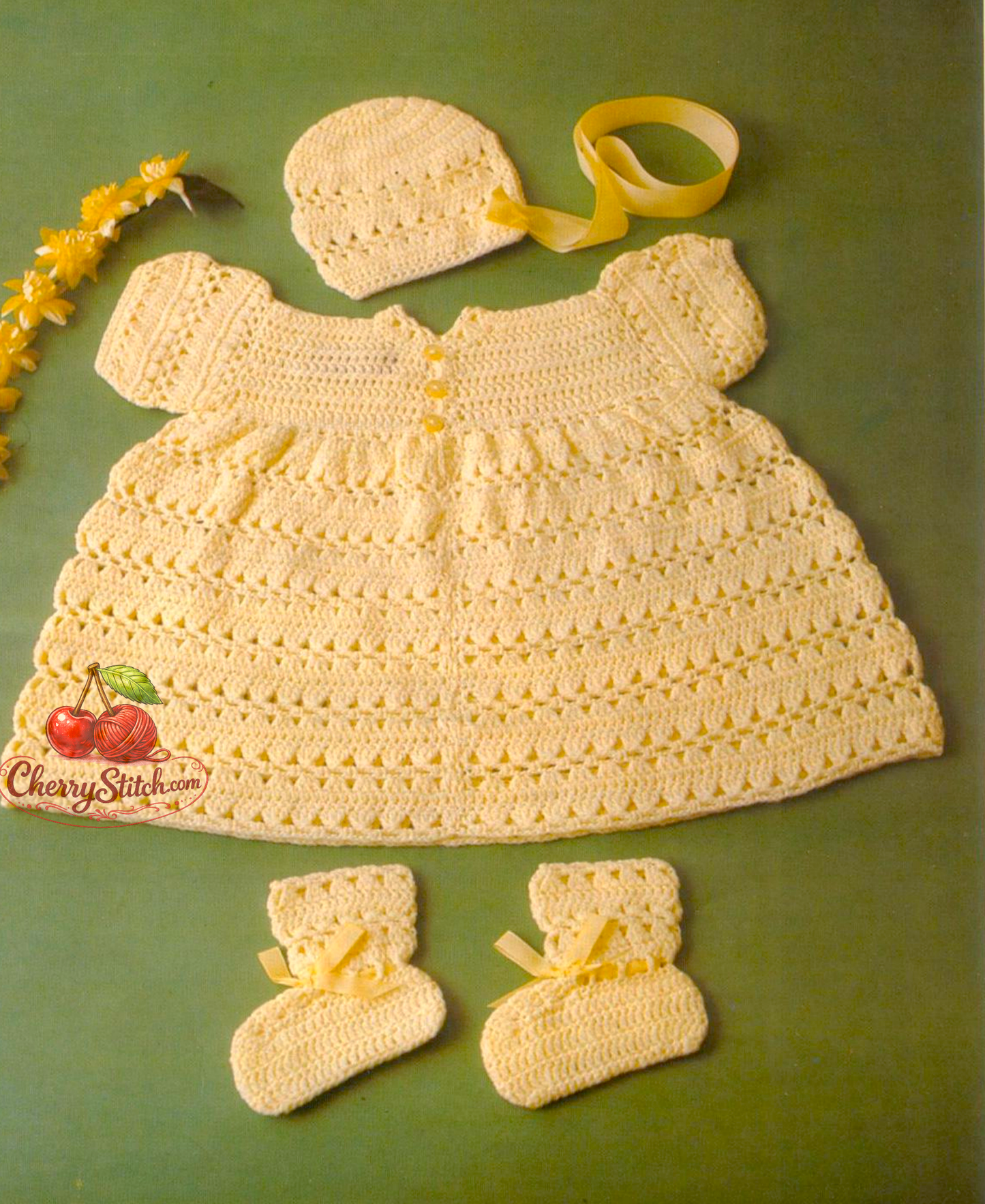 Vintage 1970s baby girl dress, bonnet and bootees crochet pattern. Short-sleeved dress in shell stitch with matching accessories. 3ply yarn, 16'' – 18'' – 20'' (40 – 45 – 50 cm), approx. Birth – 6 months and 12 months. UK crochet terms.