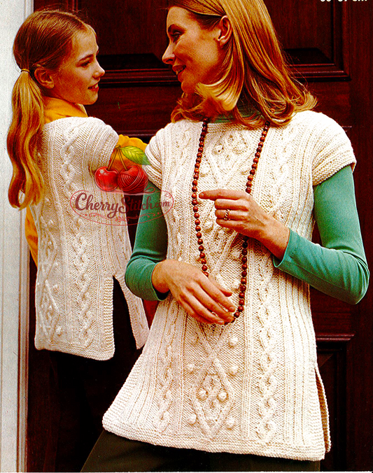 Vintage 1970s women's and girls' cable tunic knitting pattern. Bold diamond cable panels, round neck, side slits and drop shoulders. Aran yarn, 26'' – 28'' – 30'' – 32'' – 34'' – 36'' – 38'' (66 – 71 – 76 – 81 – 86 – 91 – 97 cm) chest. Approx. age 6 years to adult. Intermediate knitting. Mother-and-daughter matching pattern.