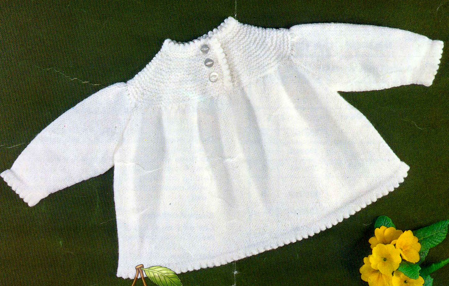 Close-up of knitted baby angel top in stockinette stitch – restored vintage 1970s pattern in DK, QK and 4-ply