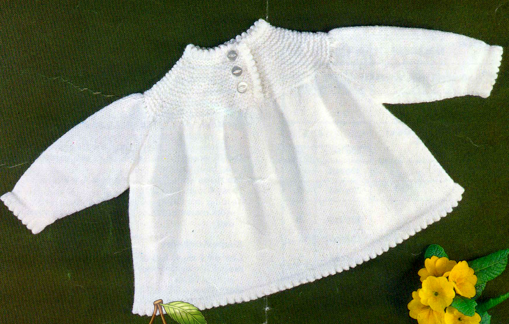 Close-up of knitted baby angel top in stockinette stitch – restored vintage 1970s pattern in DK, QK and 4-ply
