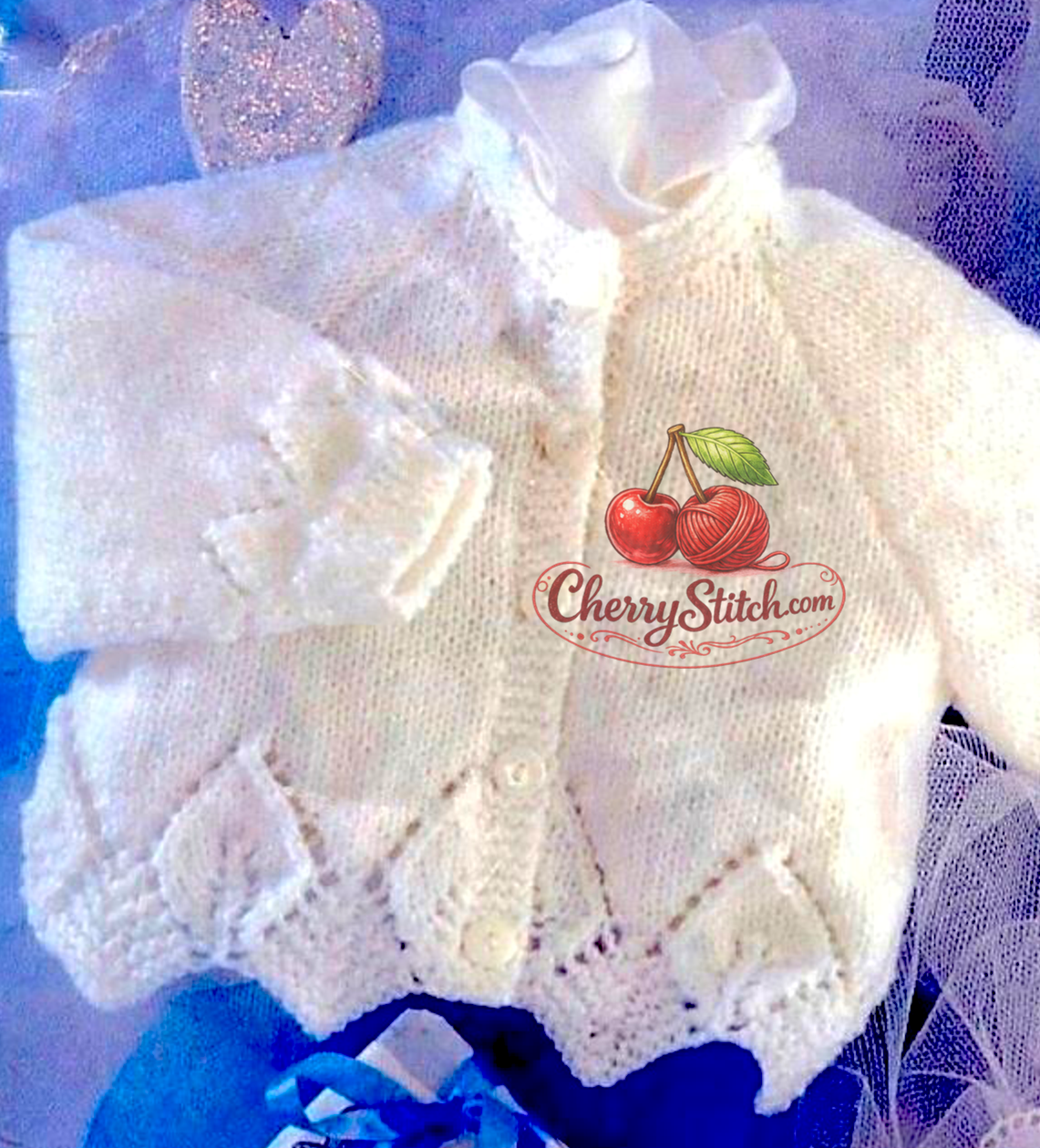 Close-up of leaf lace hem on vintage baby girl cardigan knitting pattern. Restored elegant design — stocking stitch body, round and V-neck options, raglan sleeves, DK yarn, 16''–26''.