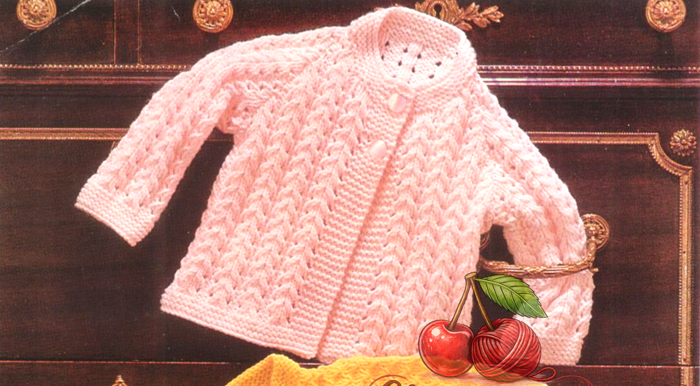Close-up of pink knitted baby raglan jacket – restored vintage 1980s textured stitch pattern