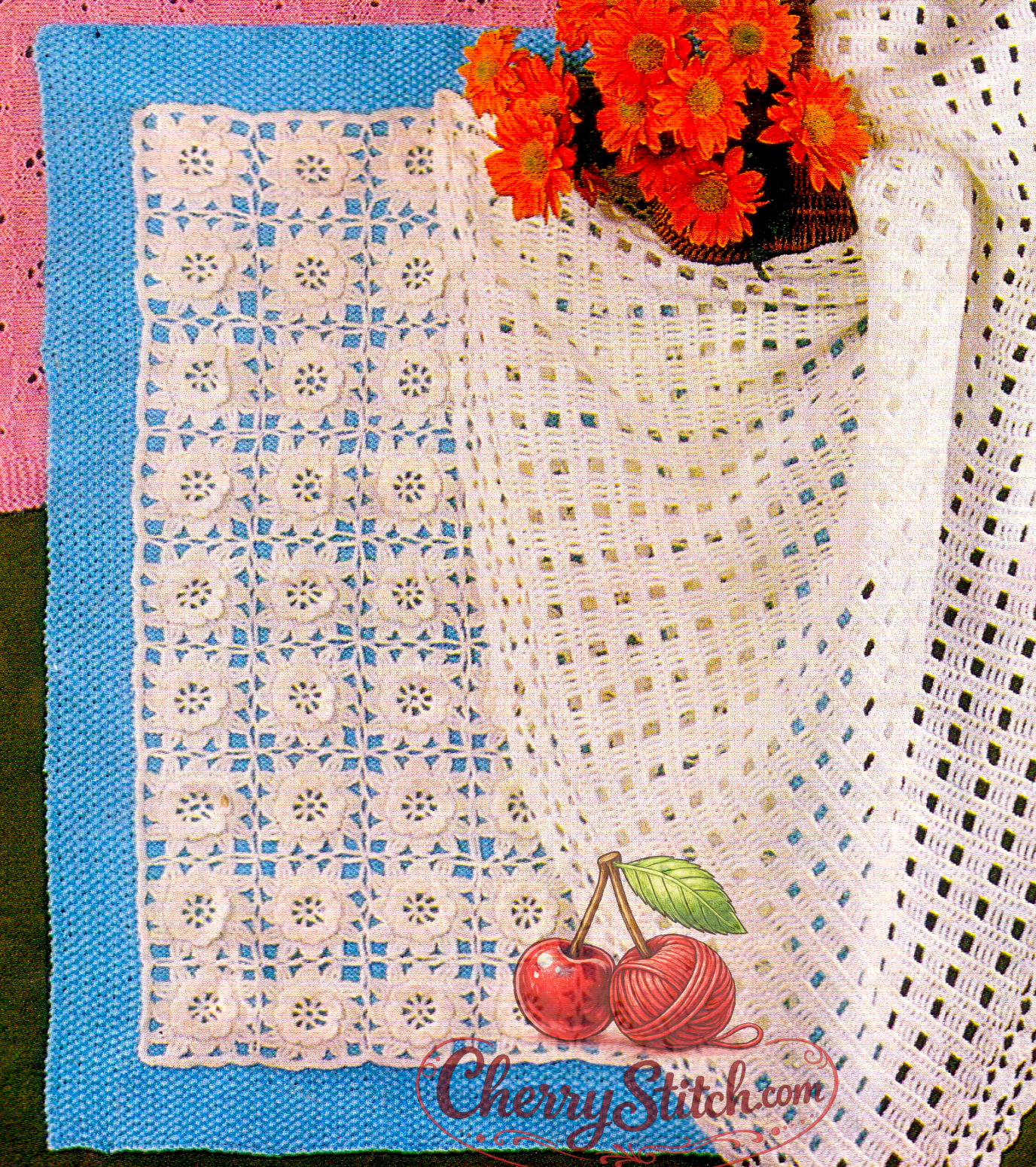 Close-up of blue and white knit and crochet baby cover with flower motifs – restored vintage 1980s pattern