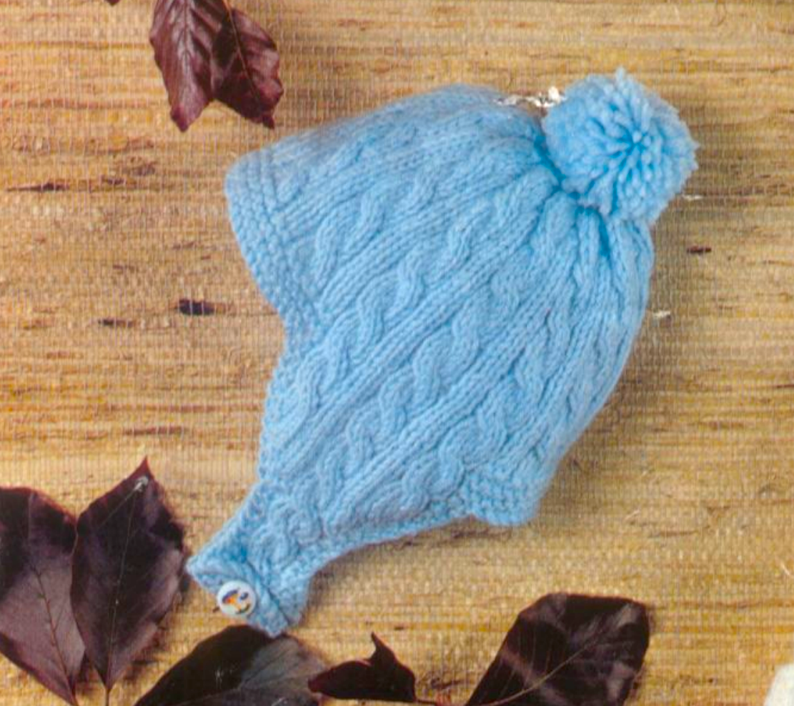 Close-up of blue knitted baby helmet in cable pattern – restored vintage 1980s boys hats knitting pattern