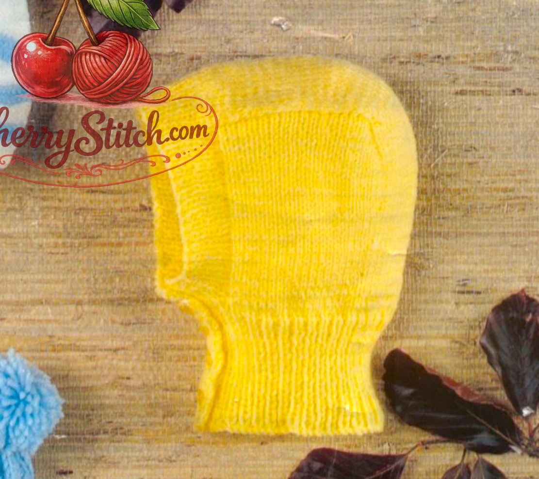Close-up of yellow knitted baby balaclava – restored vintage 1980s boys hats knitting pattern