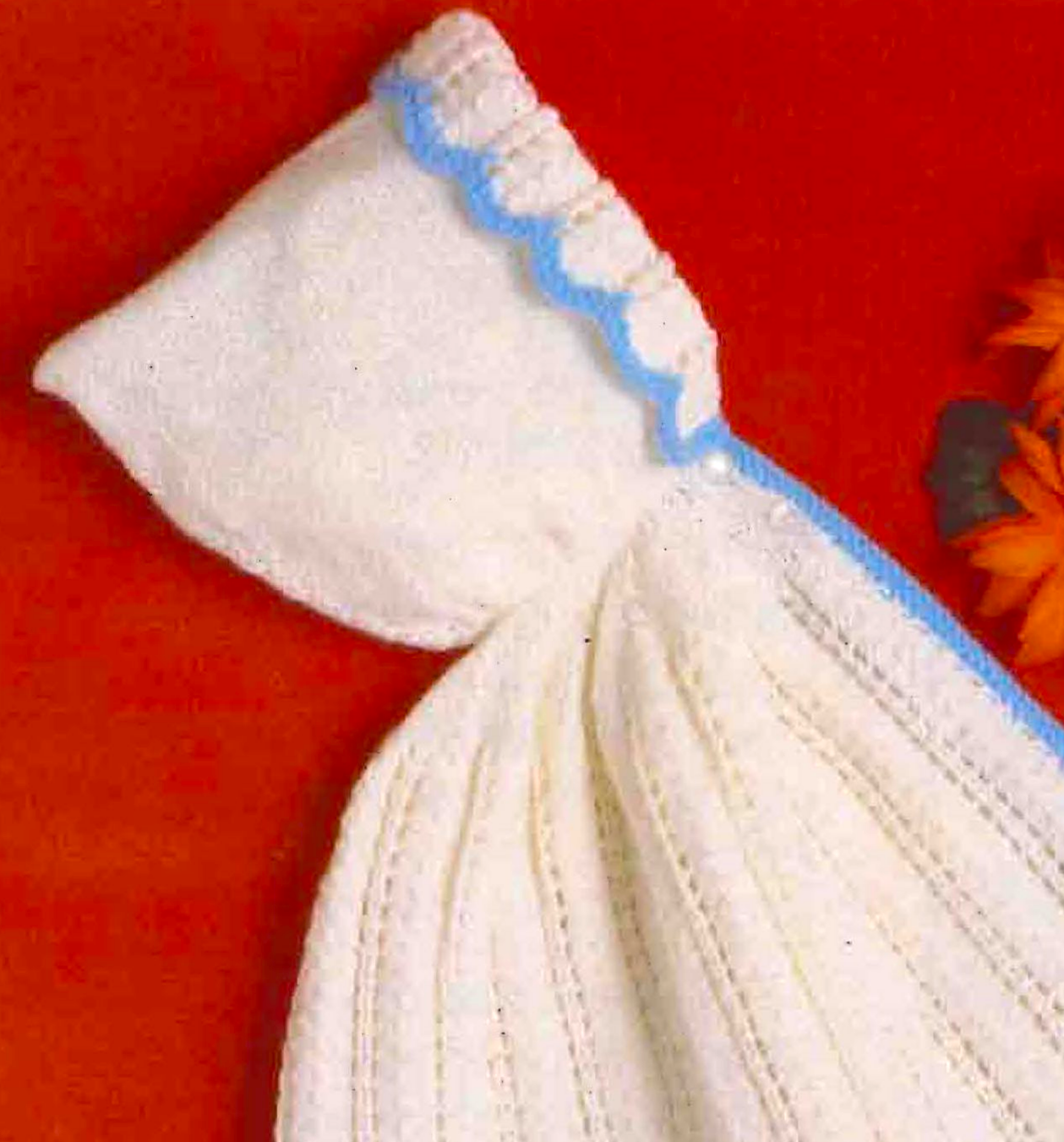 Close-up of knitted baby hood with lacy brim – restored vintage 1970s baby cape knitting pattern