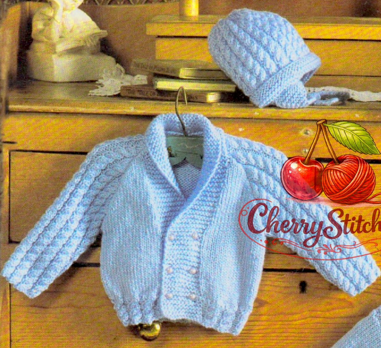 Close-up of knitted baby boy cable shawl collar double-breasted jacket and hat – restored vintage 1980s layette pattern