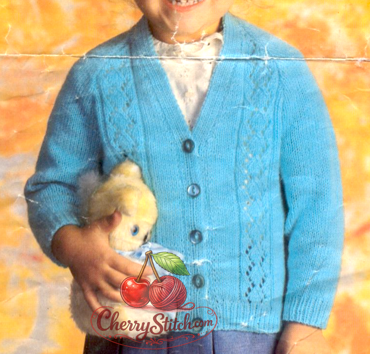 Close-up of raglan shaping and V-neck detail on vintage 1980s baby child cardigan knitting pattern