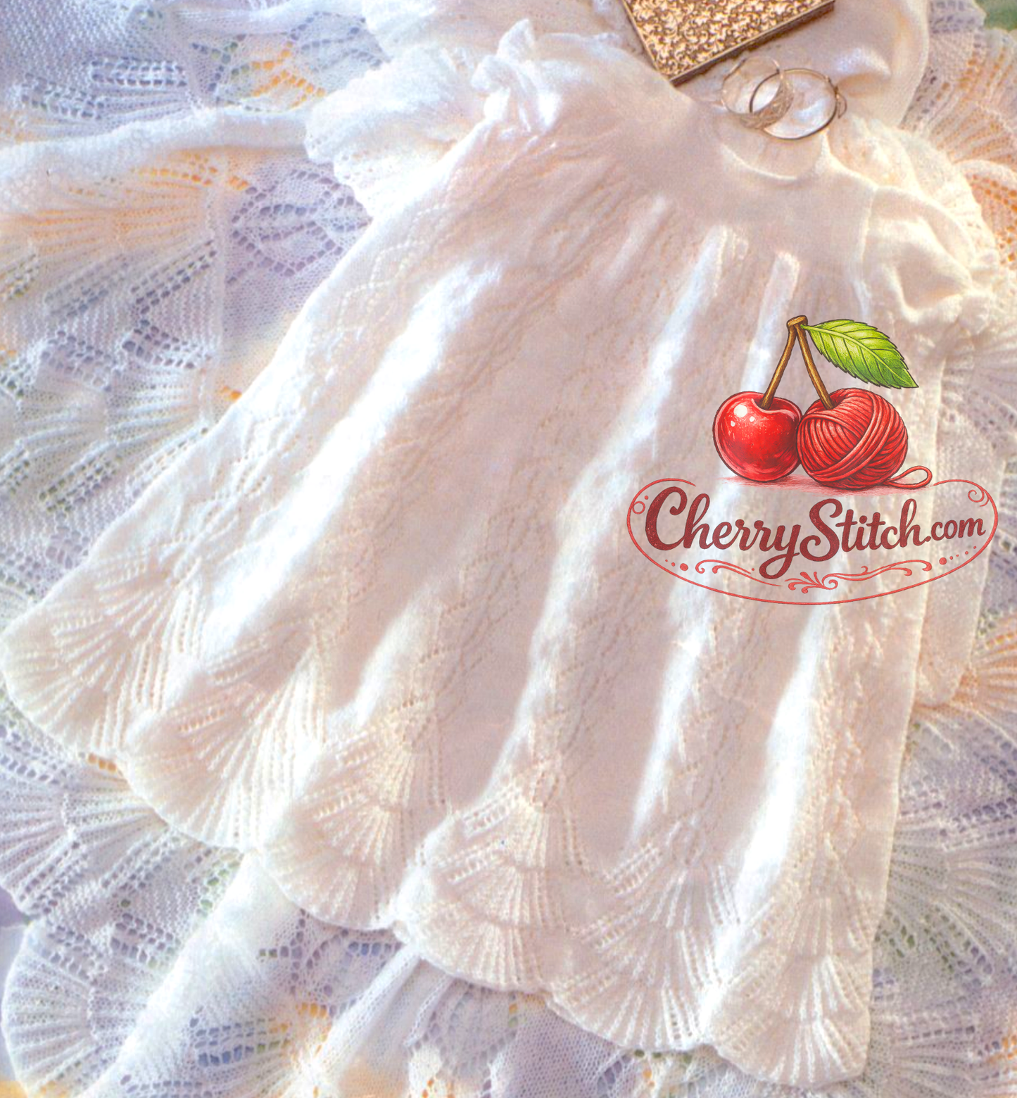Close-up of baby christening robe lace panel skirt and scalloped hem – vintage 1990s knitting pattern 3-ply