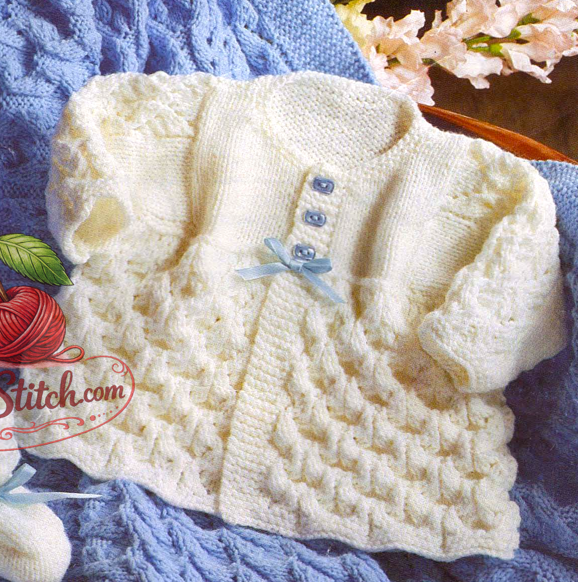 Close-up of knitted baby coat in textured stitch – restored vintage 1970s pattern in DK