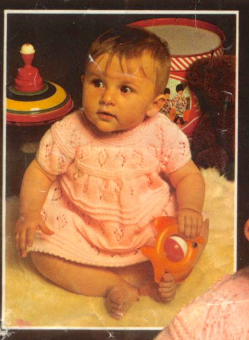Close-up of baby flared lacy dress diamond lace yoke – vintage 1970s dress and coat knitting pattern DK