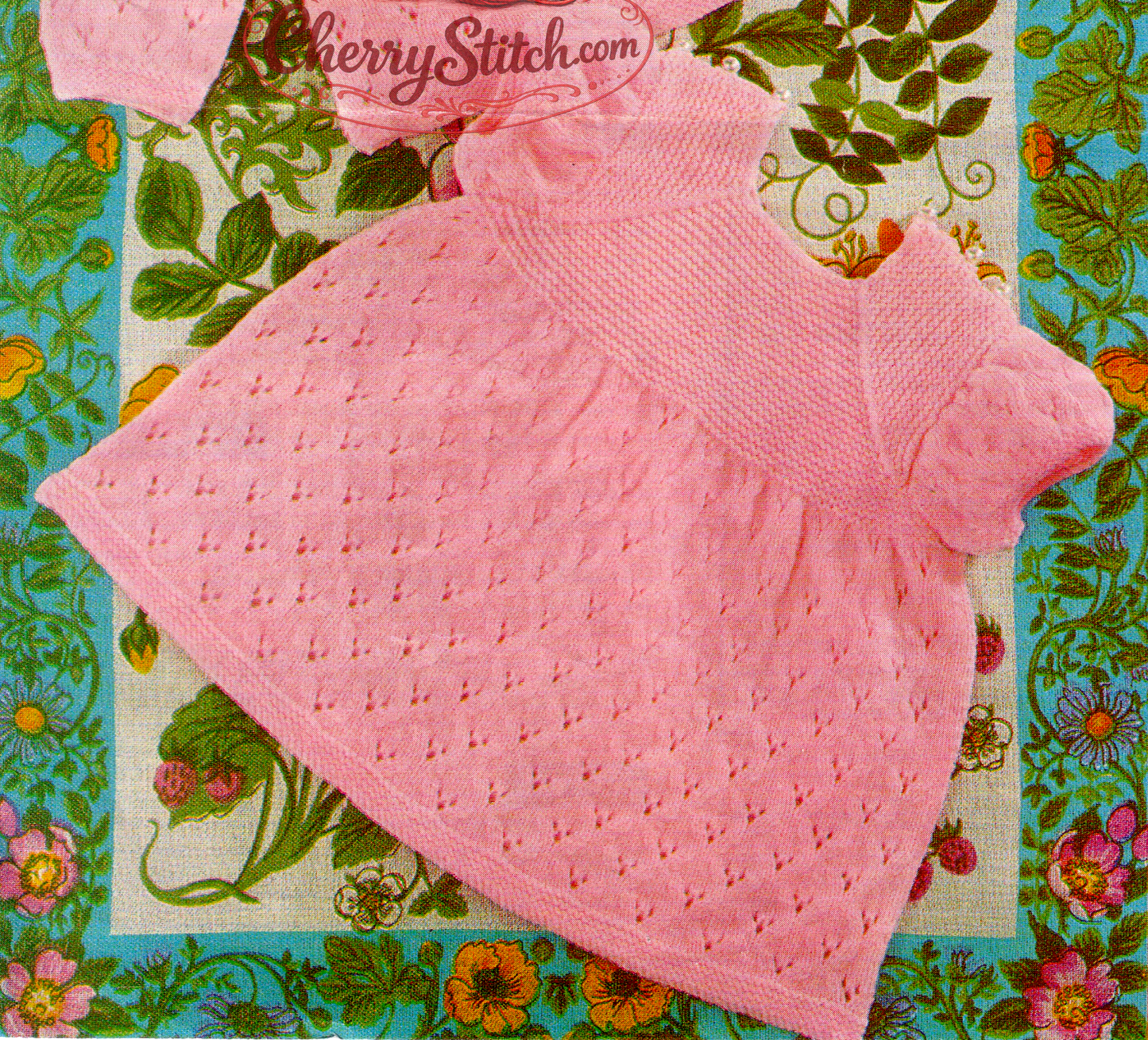 Close-up of knitted baby dress with garter stitch yoke and eyelet lace body – restored vintage 1980s pattern