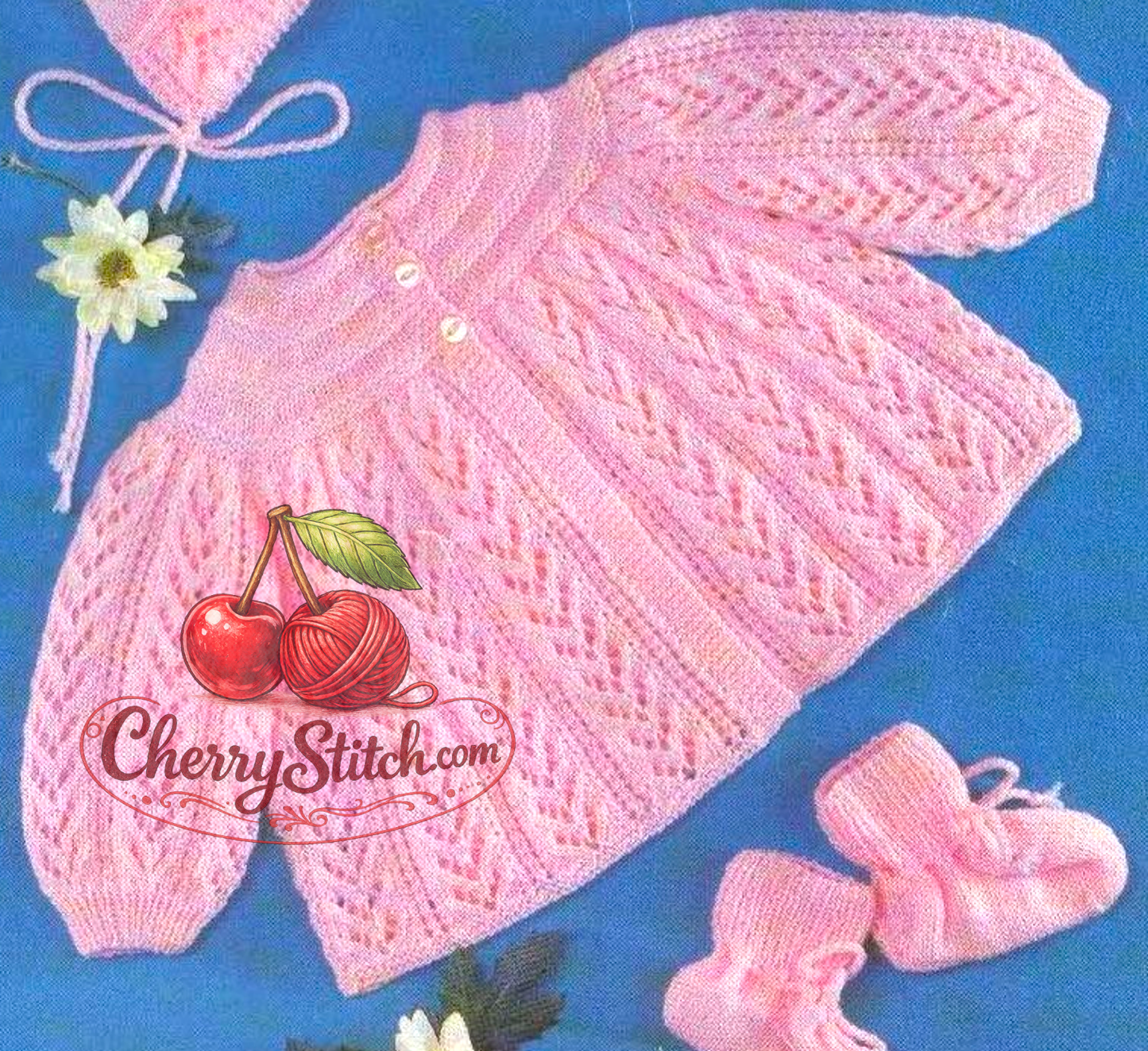 Close-up of knitted baby pink lacy matinee coat – restored vintage 1970s pattern with bonnet and bootees in 3-ply