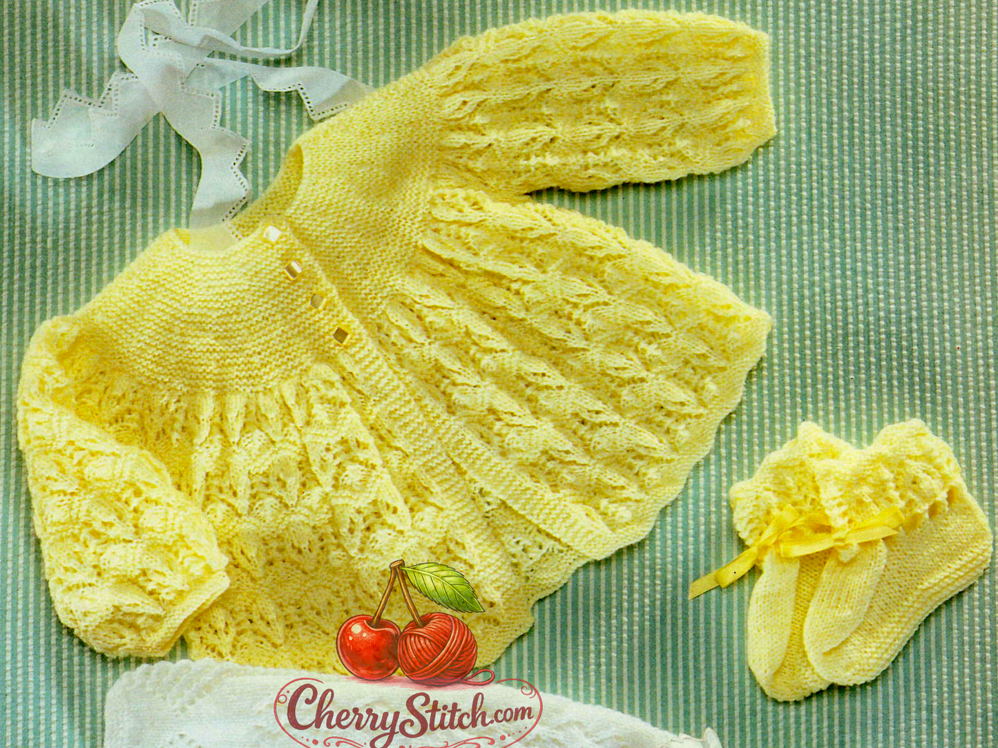 Close-up of baby matinee coat and bootees arrowhead lace garter stitch yoke – vintage 1990s knitting pattern 3-ply