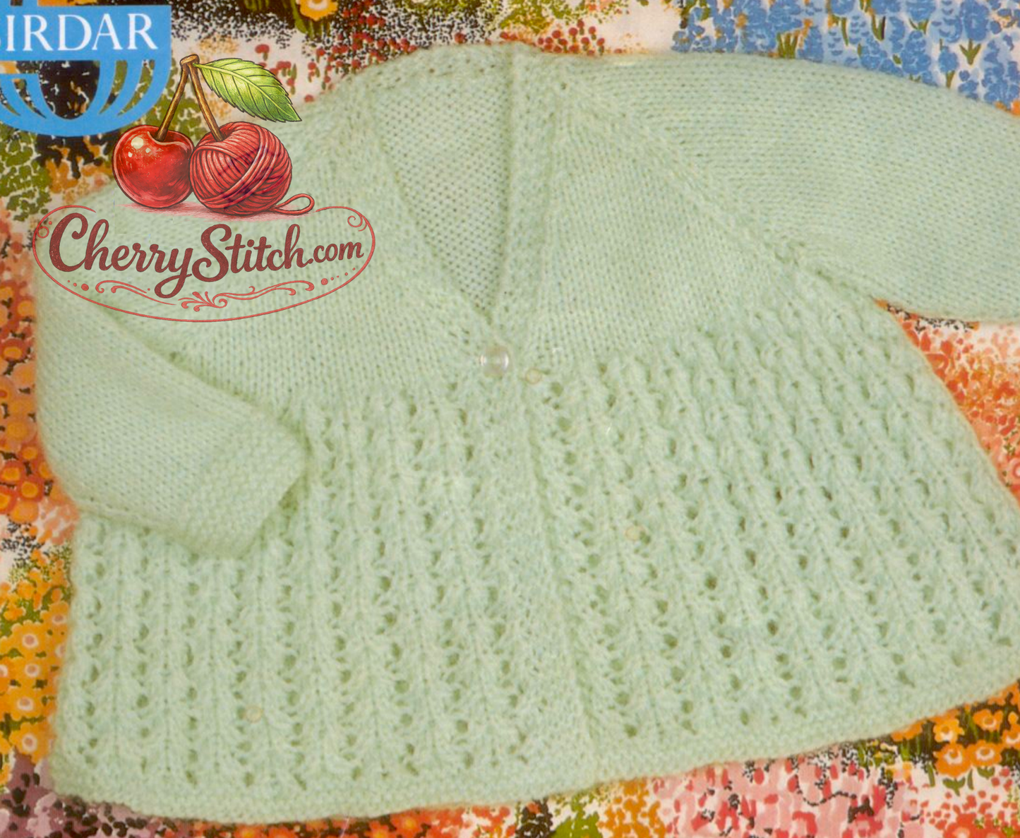 Close-up of V-neck version – restored vintage 1970s baby lacy matinee coat knitting pattern with raglan sleeves in DK