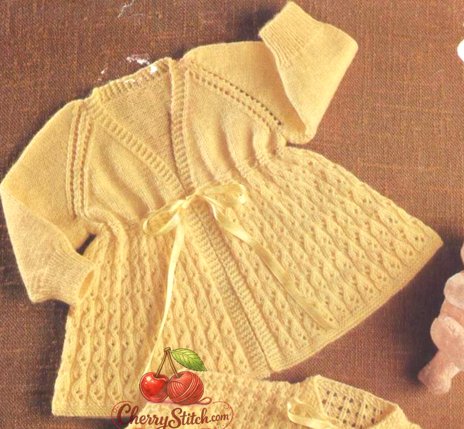 Close-up of  vintage 1960s baby matinee coat knitting pattern – v-neck coat