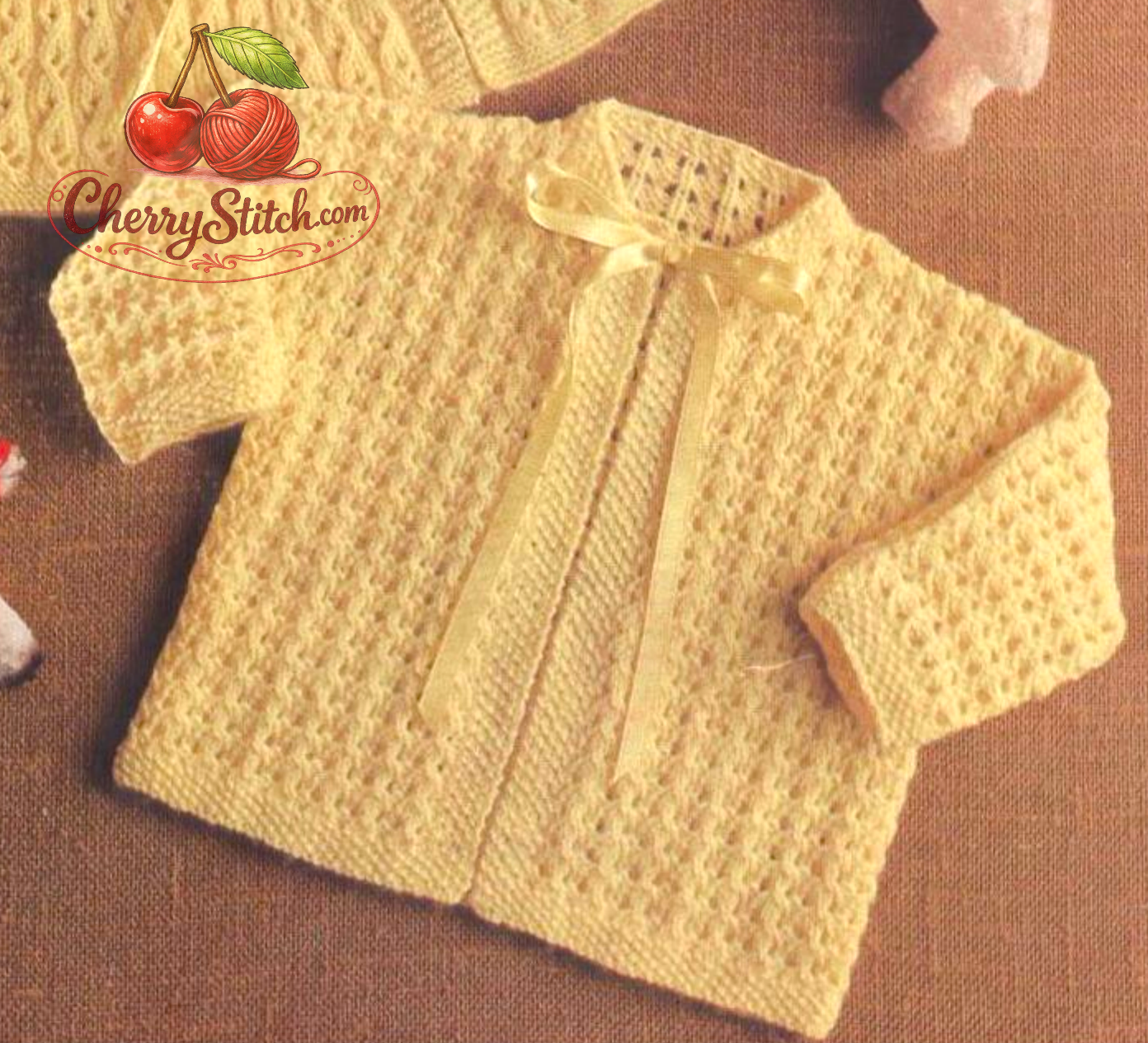 Close-up of vintage 1960s baby matinee coat knitting pattern – round neck coat