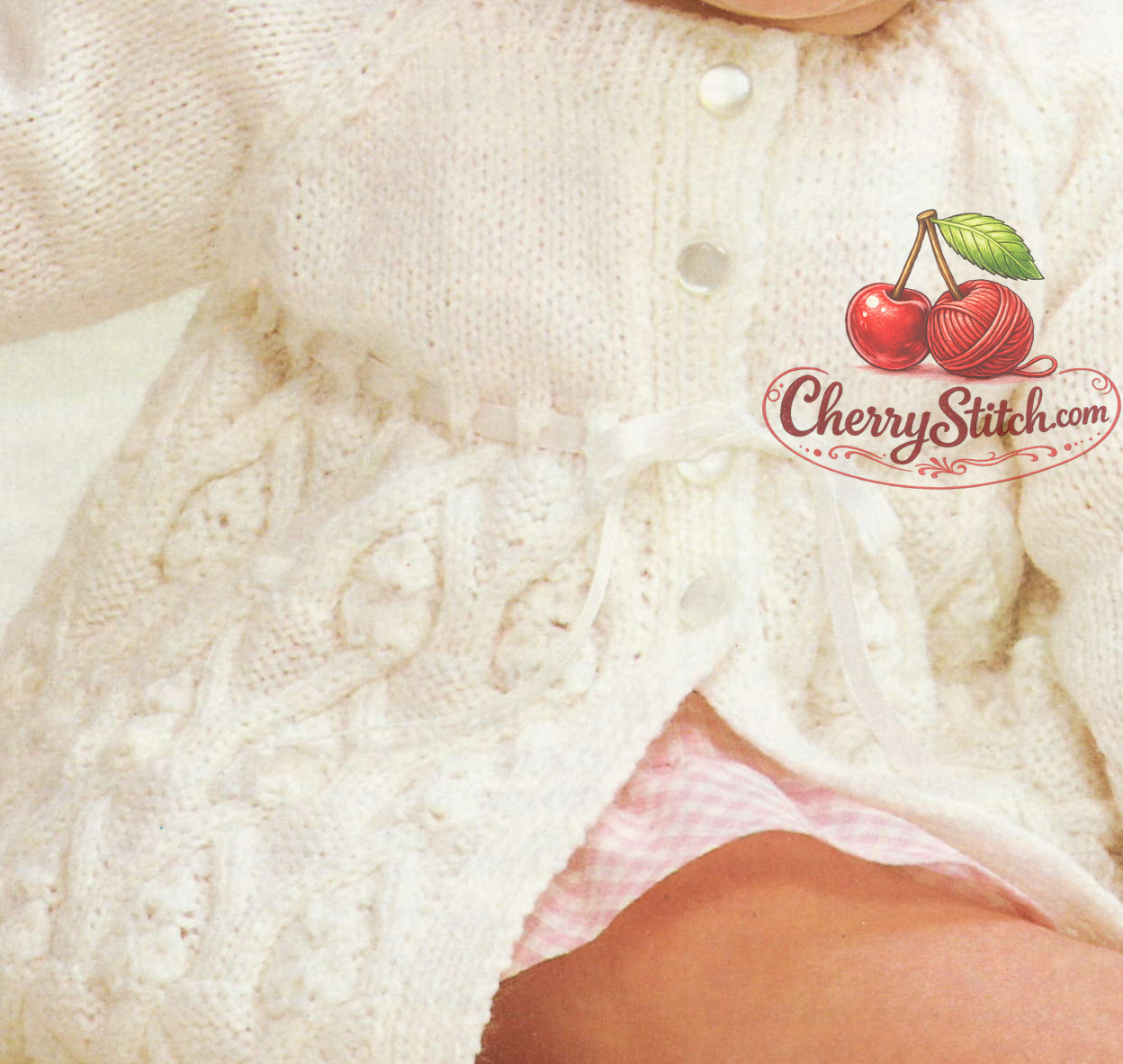 Close-up of intricate cable stitch pattern in the skirt – restored vintage 1970s baby matinee jacket cardigan knitting pattern in DK