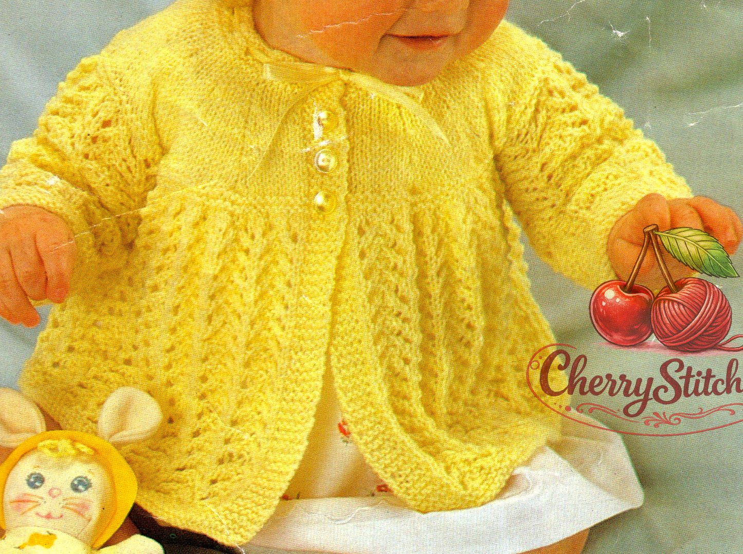 Close-up of lace skirt and stocking stitch yoke detail – restored vintage 1970s baby matinee jacket cardigan knitting pattern