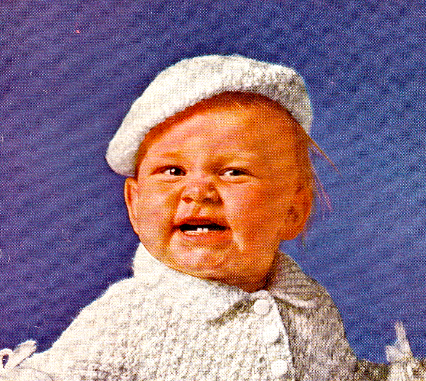 Close-up of white knitted baby beret – restored vintage 1950s Bairnswear pram set knitting pattern