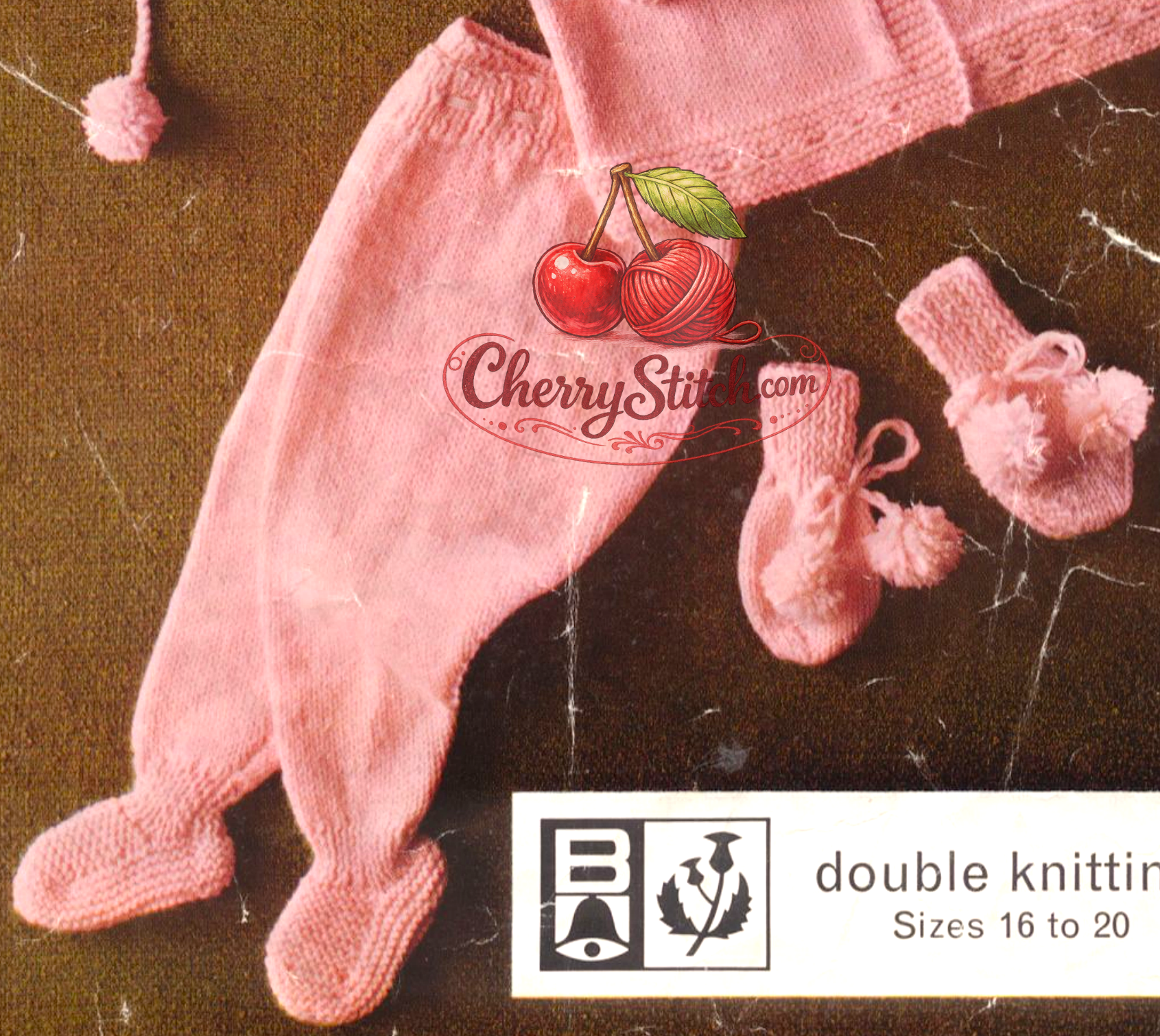 Close-up of knitted baby leggings and mittens – restored vintage 1960s pram set pattern