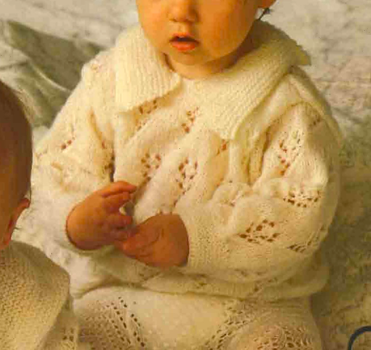 Close-up of lacy stitch detail on vintage 1970s baby toddler angel top knitting pattern in 4-ply