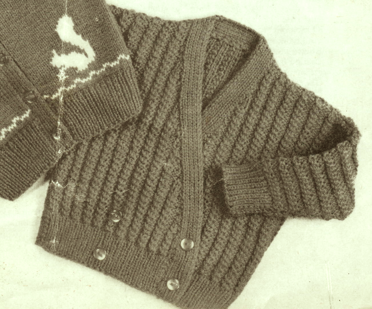 Close-up of cross-over front cardigan – restored vintage 1950s baby toddler knitting pattern in DK