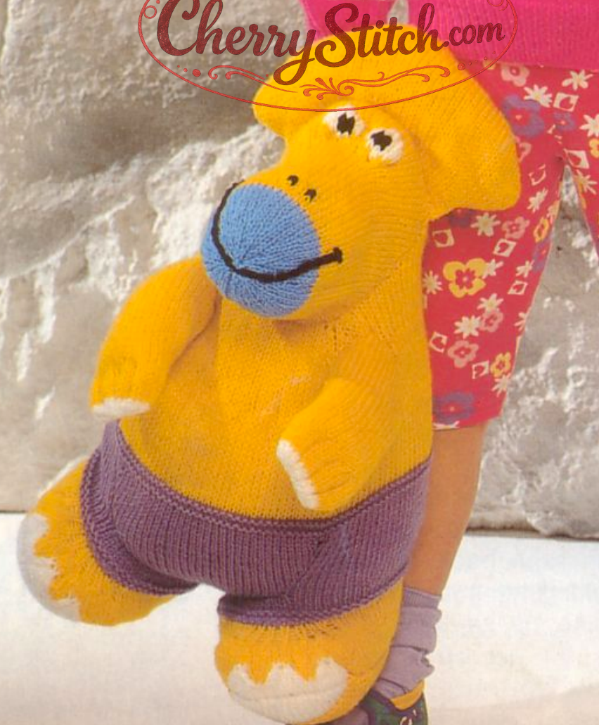 Close-up of knitted Protoceratops dinosaur soft toy – matching vintage 1980s knitting pattern DK