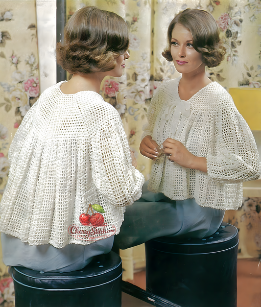 Cover art for a vintage 1970s crochet pattern featuring a woman wearing a white shell stitch bed jacket with puffy sleeves, buttoned at the front.